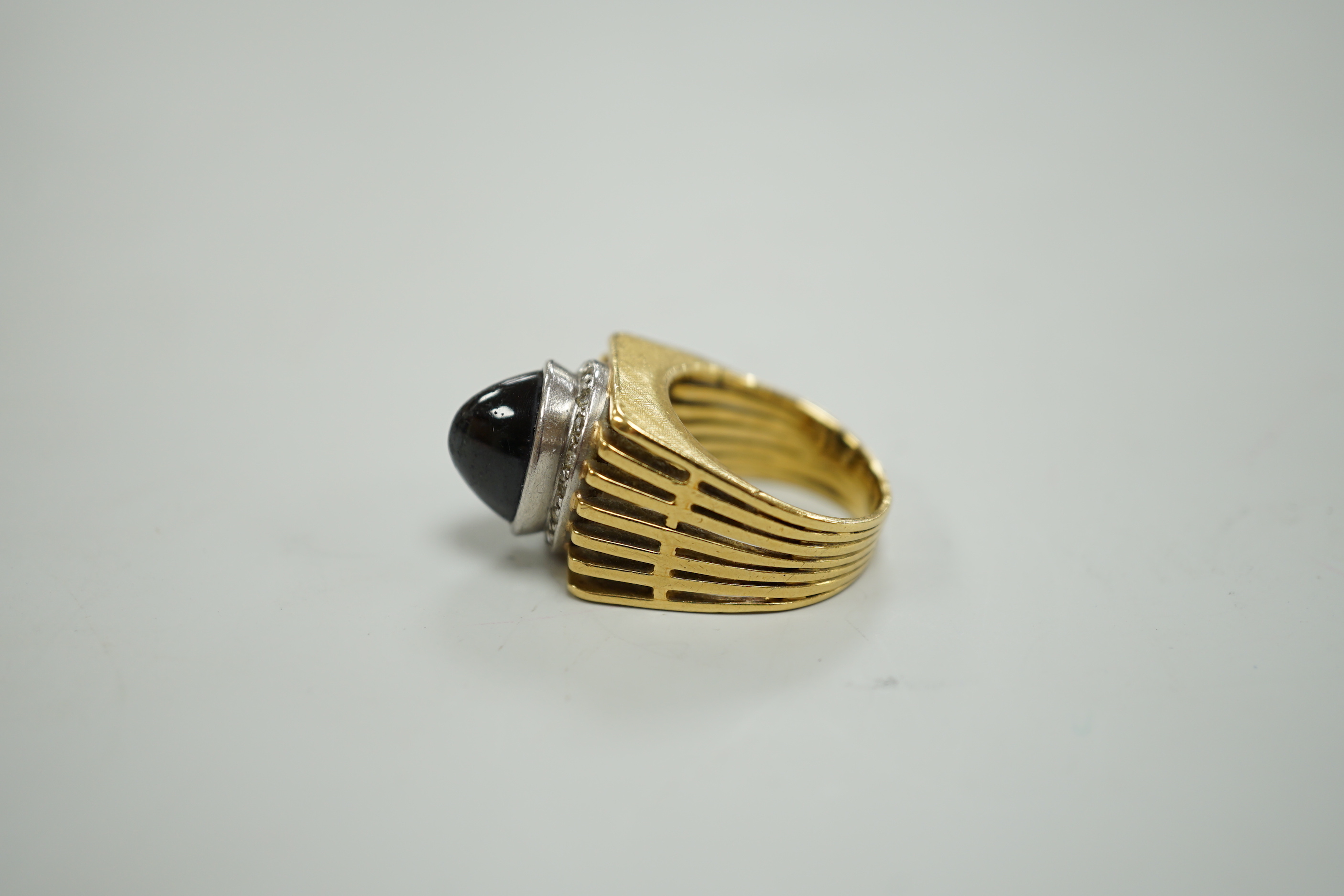 A pierced yellow metal, cabochon sapphire and diamond chip cluster set dress ring, size M, gross weight 13.4 grams.